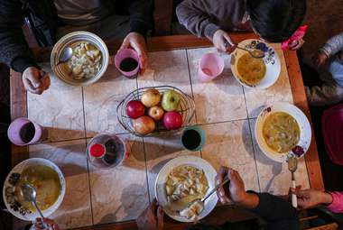 A Chilean family sits around their dining table in Santiago. Researchers in Latin America have linked higher rates of depression to increased household density.  (AP Photo/Esteban Felix)