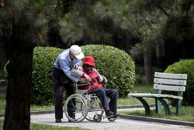 Caring for a disabled spouse may have positive mental health benefits. (AP Photo/Andy Wong)